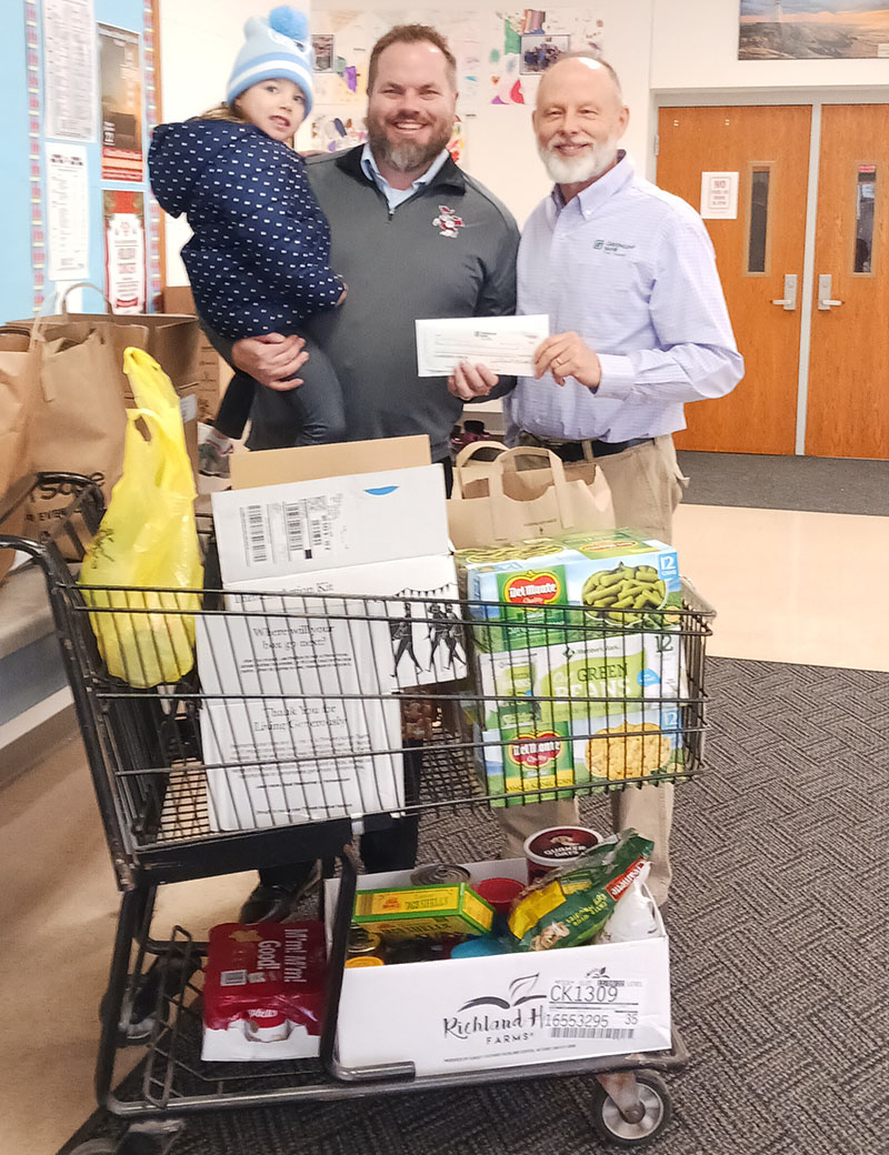 Joel Prunty with GreenLeaf Bank presents donation check to Pastor James Enderle in Morrison.